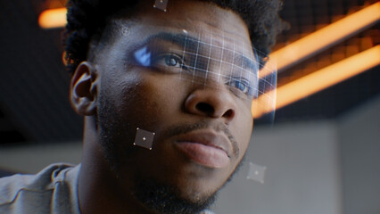 Face portrait of young African American man with concentrated look. 3D animation of human futuristic biometric AI facial recognition. Identification for access. Privacy and modern scanning technology.