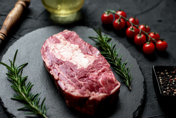 raw marbled beef steak on stone background