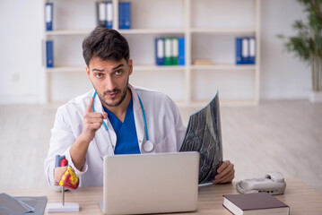 Young doctor radiologist sitting at the hospital