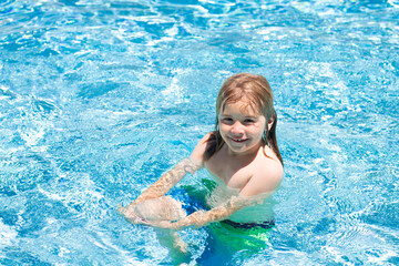 Summer vacation. Cute kid in swimming pool. Children play in tropical resort. Family beach vacation and summer activity.