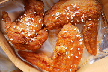 Crispy fried chicken wings on a plate top view .