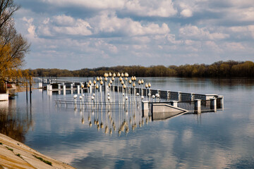 Fototapeta premium Landscape with river, forest and embankment in the city in spring. Flood and flood of river water in spring. Rivers of Belarus. the city of Gomel. Europe.