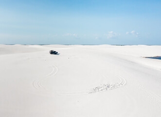 offroad car on the  white dunes filled with rain water of Lencois Maranhenses © Agata Kadar
