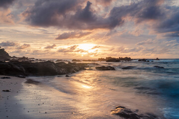 Obraz premium Best sunset over the sea on a tropical beach in wediombo beach, central java, indonesia