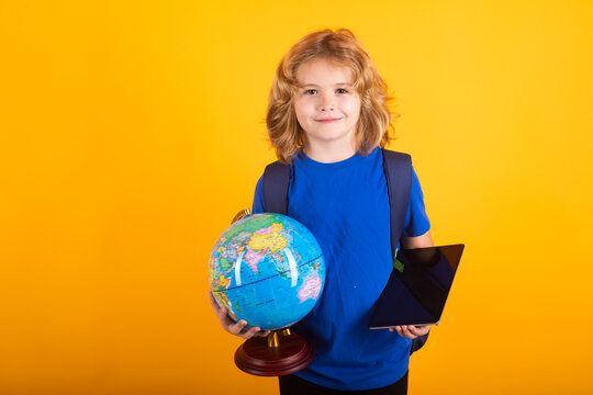 School boy world globe and tablet. Child from elementary school with book isolated on yellow background. Little student, clever nerd pupil ready to study. First time to school. - Powered by Adobe