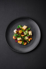Delicious fresh vegan salad with pear, brie cheese, nuts and grains, and arugula