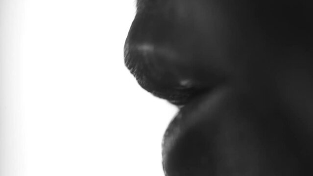 Black and white video of woman's mouth talking or singing. Artistic. Macro.