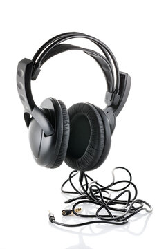 Black wired headphones. Headphones isolated on white background.