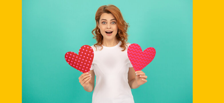 happy young woman with red heart on blue background. wow