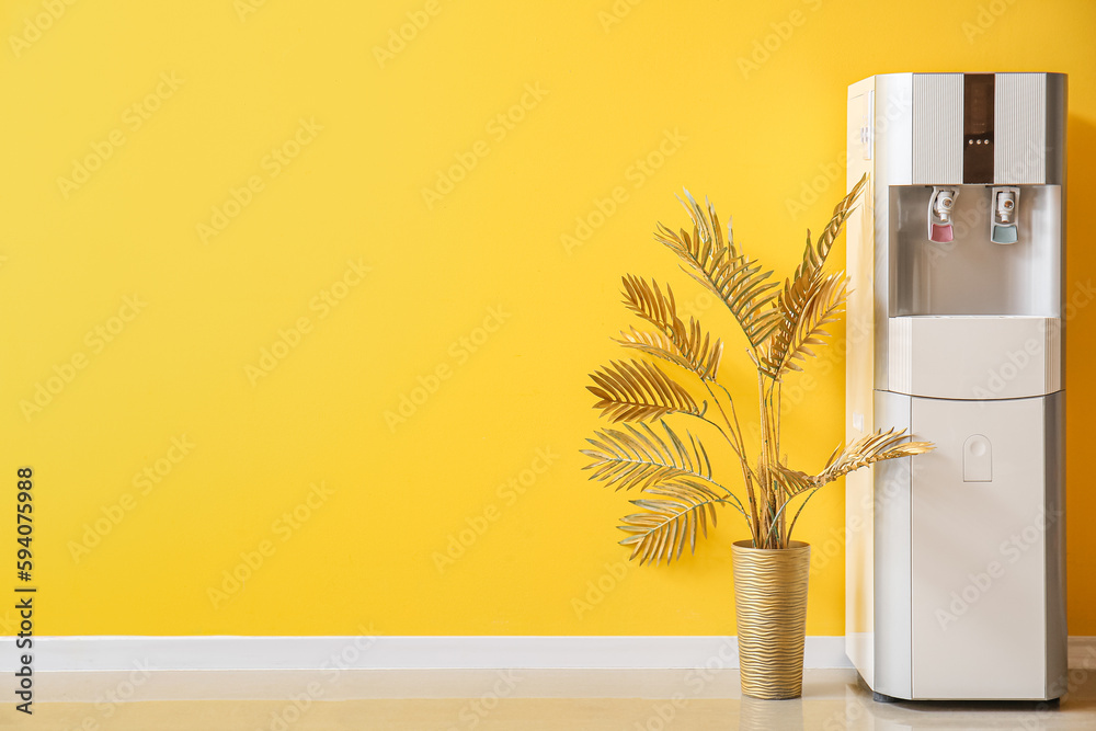 Sticker Modern water cooler and vase with palm leaves near yellow wall