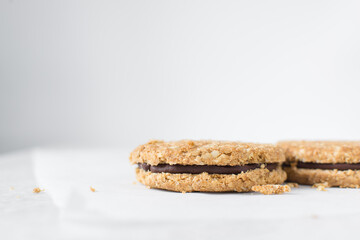 oat cookies with chocolate filling, homemade oatmeal cookies filled with chocolate ganache, thin oat biscuits with chocolate ganache