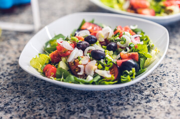 Salad with cherry tomatoes, onion and olives