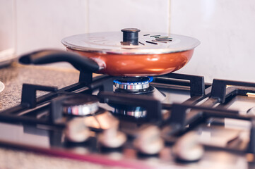 Fototapeta na wymiar Brown pan on a domestic cooker.