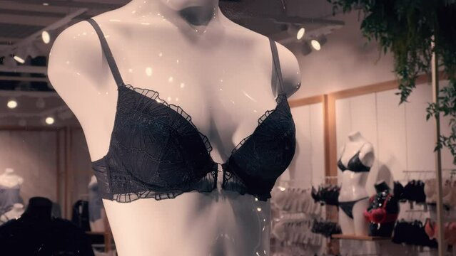 Black bra worn on a woman's mannequin in a lingerie store window