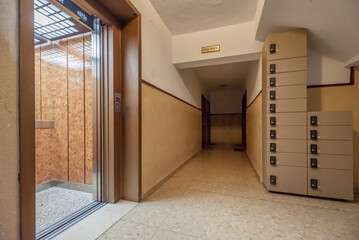 Access door to an elevator and mailboxes to collect postal shipments
