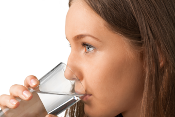 Portrait of a Young Woman Drinking a Glass of Water