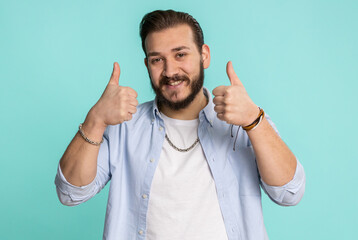 Like. Lebanese young man in shirt raises thumbs up agrees with something, gives positive reply...