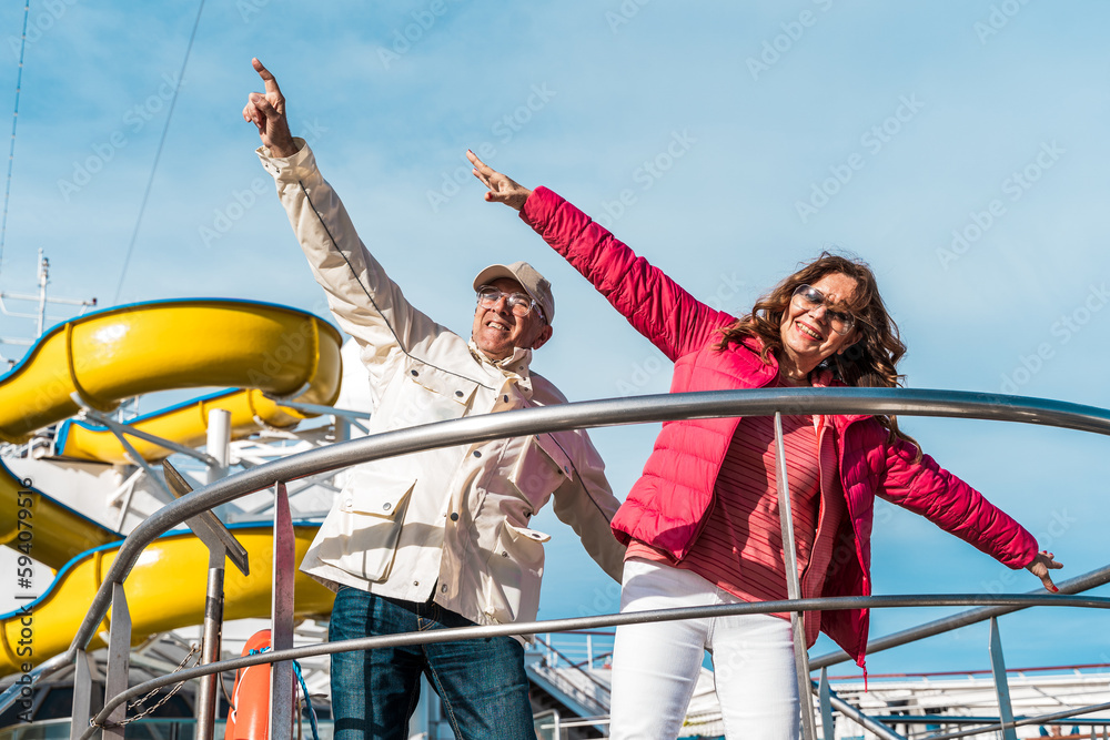 Wall mural beautiful happy middle aged couple having fun on the deck of a cruise ship