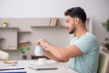 Young male freelancer working from home