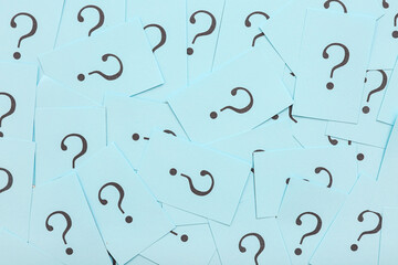 Blue papers with question marks as background