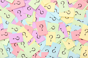 Colorful papers with question marks as background