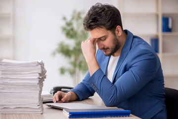 Young male employee working in the office