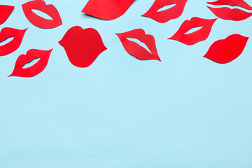 Red paper lips on blue background