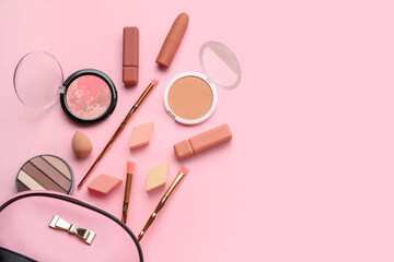 Cosmetic bag with makeup products and sponges on pink background