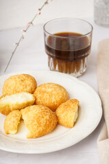 Plate with tasty choux dessert on light background, closeup