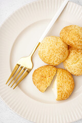 Plate with tasty choux dessert on table, closeup