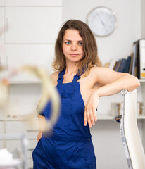 Naked female cleaning service worker posing in office.