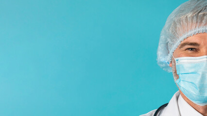 Half face of mature doctor wearing face mask and hairnet