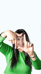 Young woman making a frame with her fingers on a white background.
