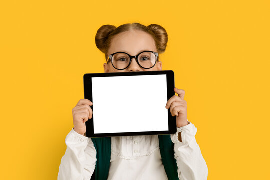 Online Ad. Cute Schoolgirl Holding Blank Digital Tablet With White Screen