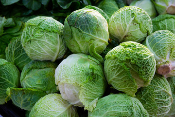 Fototapeta premium Image of fresh organic salad and cabbage in greengrocery shop
