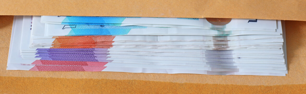 Close up of used sterling notes in a brown envelope
