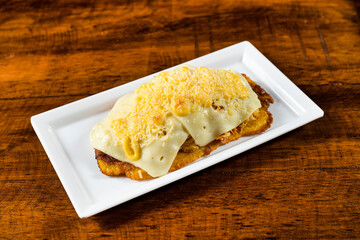 Green plantain patacon with shredded chicken and cheese - Colombian street food