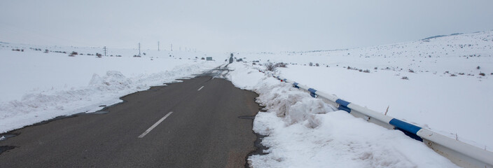 asphalt road with snowy landscape