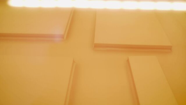 The process of pasting furniture with MDF film on equipment. Production of MDF facades using PVC film. Machine for sticking film on mdf panel close-up, front and background blurred.