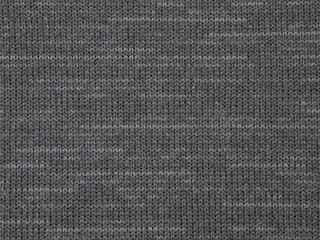 Texture detail of dark gray woven polyester material is shown in a closeup view.