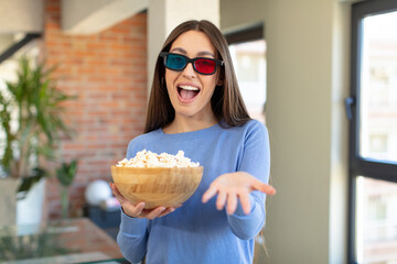 smiling happily and offering or showing a concept. popcorns and movie concept