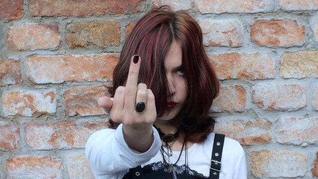 Eccentric bad girl with offensive gesture