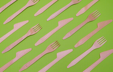 wooden forks and knives on a green background