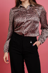 Nice girl in shirt and pants at pink background.