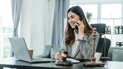 Call mobile, cellphones, Online consulting with laptop in office of asian thai japanese chinese female exclusive lawyer legal advisor, legislation, saleswoman, legal contract documents