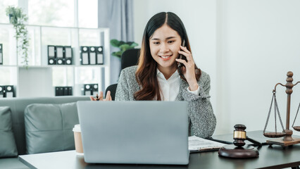 Call mobile, cellphones, Online consulting with laptop in office of asian thai japanese chinese female exclusive lawyer legal advisor, legislation, saleswoman, legal contract documents