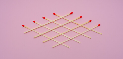 matches lined with a pattern on a pink background