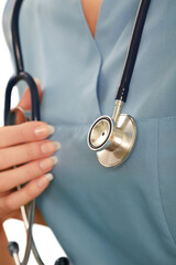 Close up of stethoscope on a female healthcare professional in scrubs