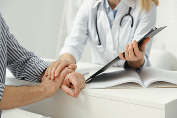 Patient having appointment with doctor in clinic, closeup