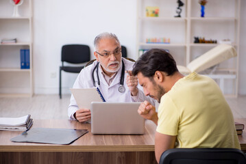 Young male patient visiting old male doctor